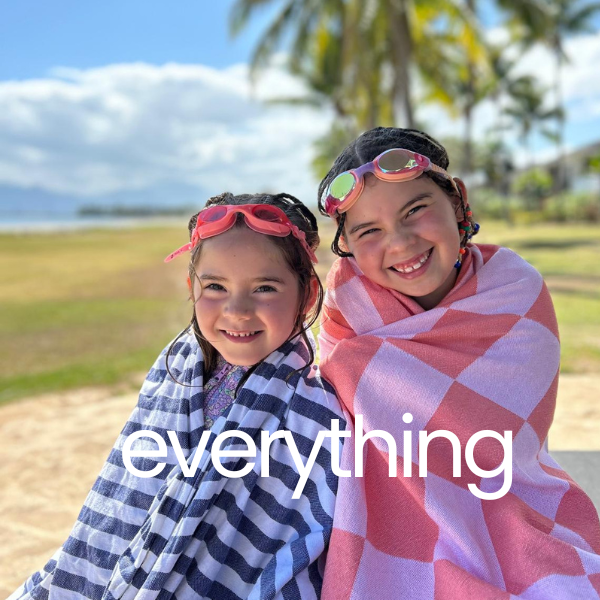 2 little girls on a tropical beach wearing Turkish Towels