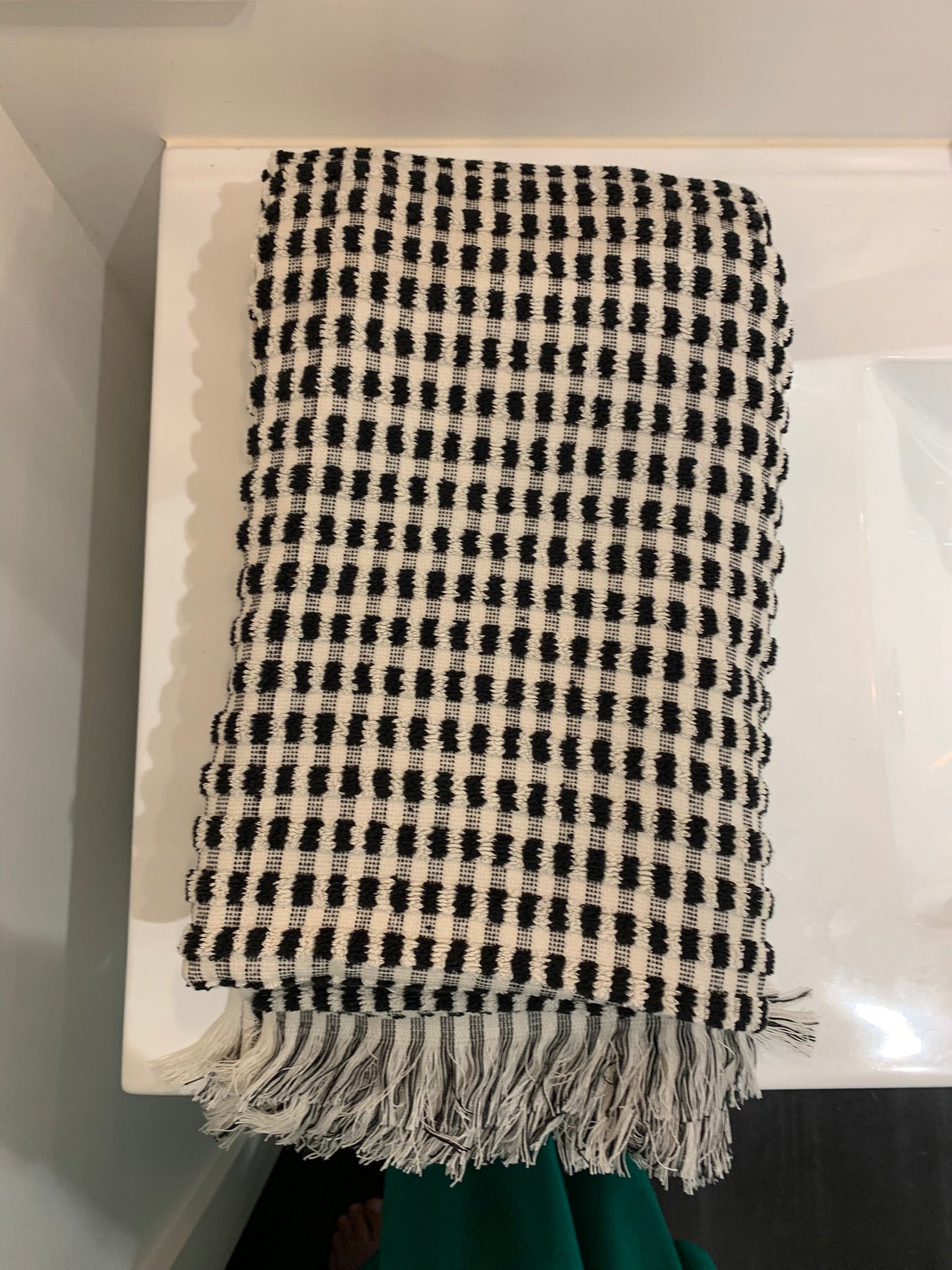 Folded large black and white dotted fluffy cotton bath towel with fringes 