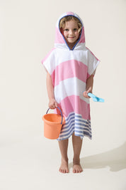 A little girl wearing the Ezy-towelie with the hood on. Stripped Turkish towel with hood in Pink and Blue.
