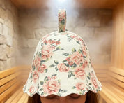 Floral-patterned wool felt sauna hat worn by a person in a sauna.