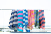 Colourful striped beach Santorini Turkish towels hanging on a line outdoors.