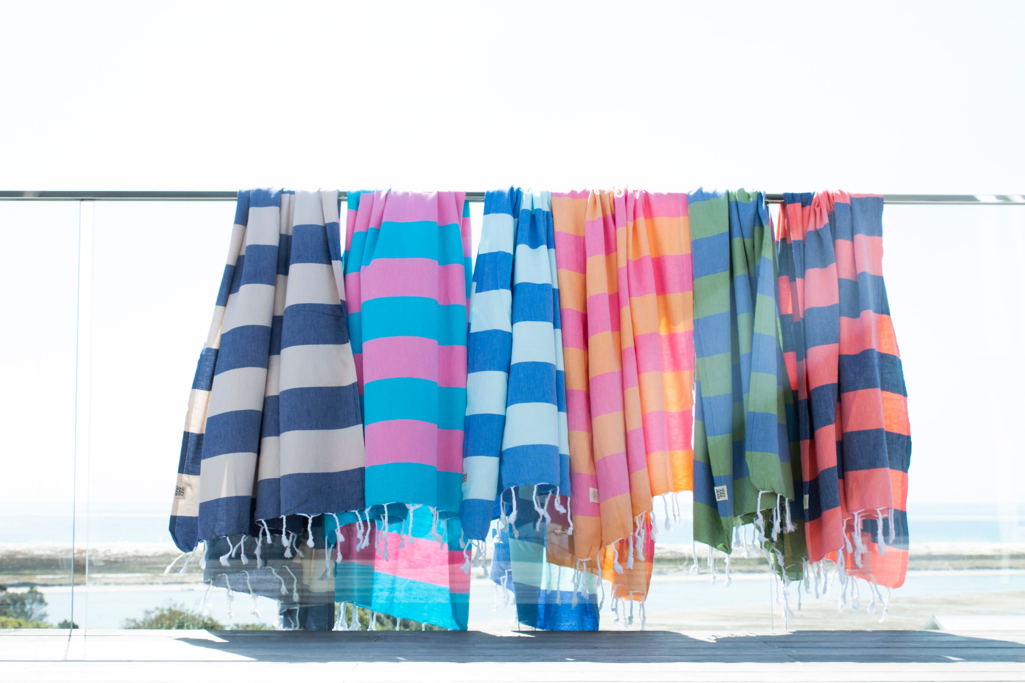 Colourful striped beach Santorini Turkish towels hanging on a line outdoors.