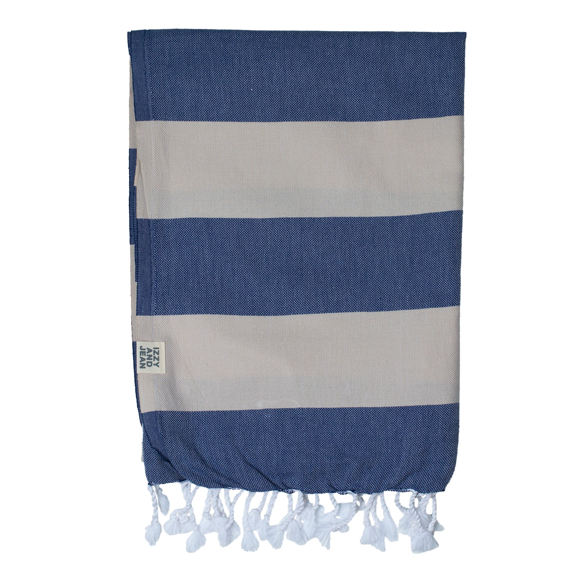 A folded striped Santorini Turkish towel with navy and sand colours, featuring white fringes on the edges.