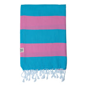 The Santorini Turkish towel with marine blue and hot pink stripes featuring white fringes at the edges.